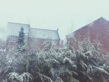 View of buildings against clear sky during winter