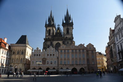 Group of people in front of buildings in city