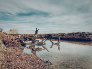 Abandoned built structure in water against sky