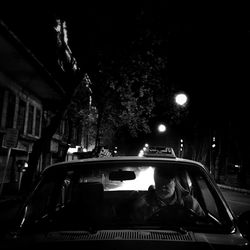 Car on illuminated road at night