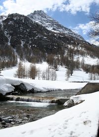 Scenic view of snow covered mountains against sky