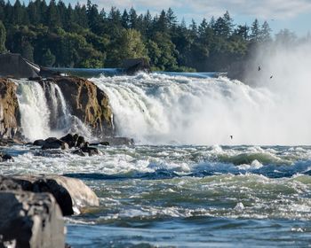 Scenic view of waterfall in sea