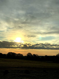 Scenic view of field against sky during sunset