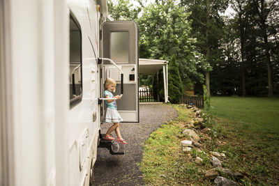 Girl moving down from steps of motor home