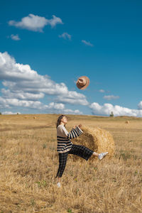 Man standing on field against sky