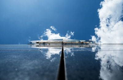 Glass building with reflection of clouds and sky on it