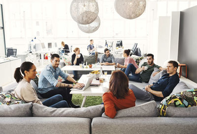 Multi-ethnic business people having discussion in modern office lobby