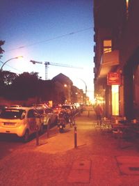 City street against sky at dusk