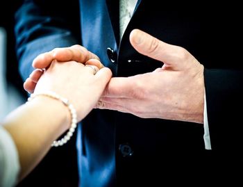 Midsection of man holding woman hand