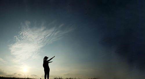 Silhouette woman standing in front of sky during sunset