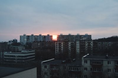 High angle view of buildings against cloudy sky