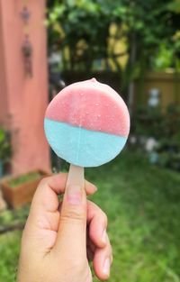 Close-up of hand holding ice cream cone