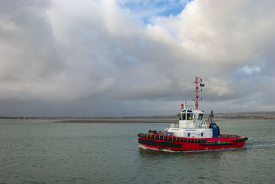 Ship sailing in sea against sky