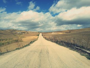 Empty road along countryside landscape