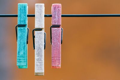 Close-up of clothespins on clothesline