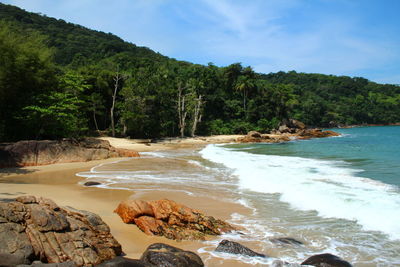 View of calm beach against mountain