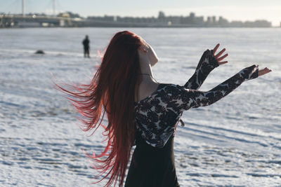 Midsection of woman standing at beach