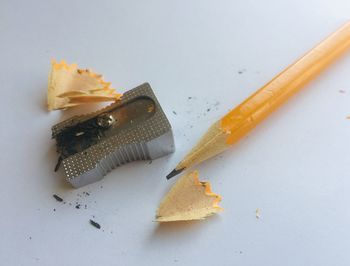 High angle view of pencil on floor against white background