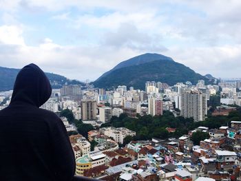 Rear view of man looking at cityscape from up high