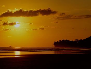 Scenic view of sea against romantic sky at sunset