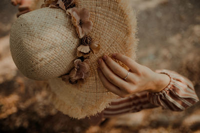 Close-up of woman holding hat