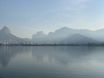 Scenic view of lake with mountain range in background