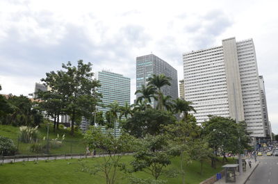 Modern buildings against cloudy sky