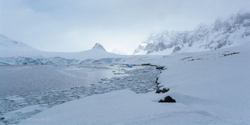 Scenic view of snow covered mountains