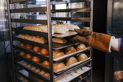 Cropped hands preparing pastry in bakery