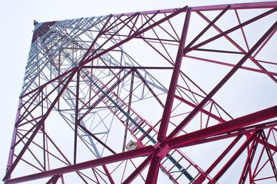 Low angle view of electricity pylon against clear sky