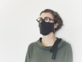 Portrait of man wearing mask against white background