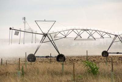 Traditional windmill on field against sky