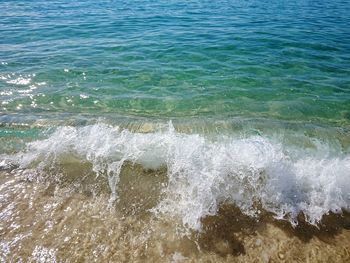 High angle view of waves splashing on shore