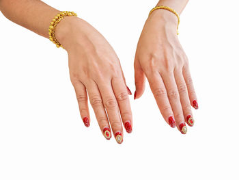 Close-up of woman hand over white background