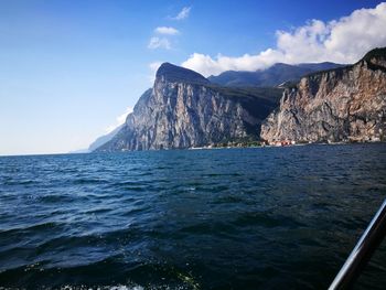 Scenic view of sea and mountains against sky