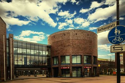Low angle view of building against cloudy sky