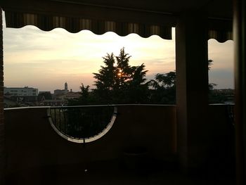 Silhouette of building against sky at sunset