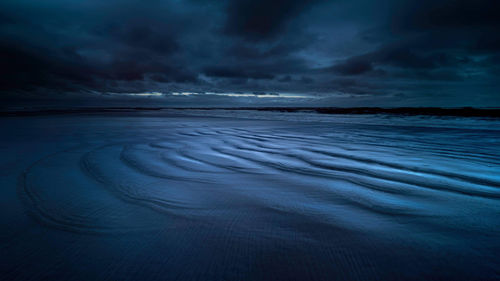 Scenic view of sea against dramatic sky