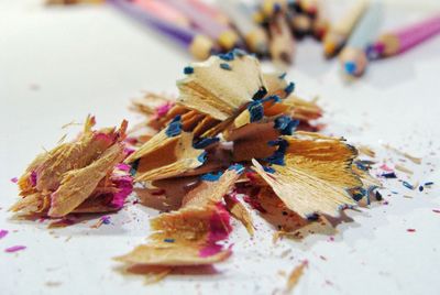 Close-up of multi colored pencils shavings on table