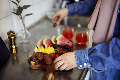 Woman's hands arranging healthy snacks