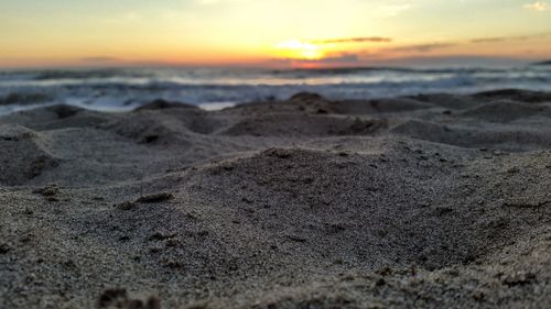 Scenic view of beach against sky during sunset