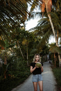 Portrait of woman drinking coconut water