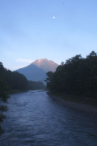 Scenic view of sea and mountains against sky