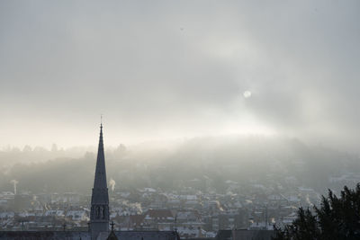 Scenic view of residential district in foggy weather