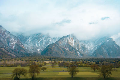 Scenic view of landscape and mountains against sky