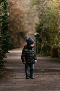 Full length of boy walking on footpath