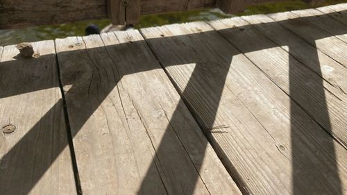 High angle view of wooden railing on footpath