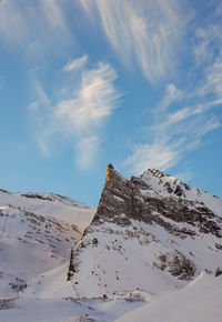 Low angle view of snowcapped mountain against sky