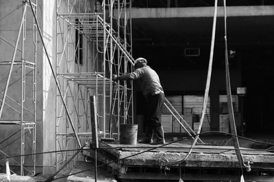 Full length of manual worker working at construction site