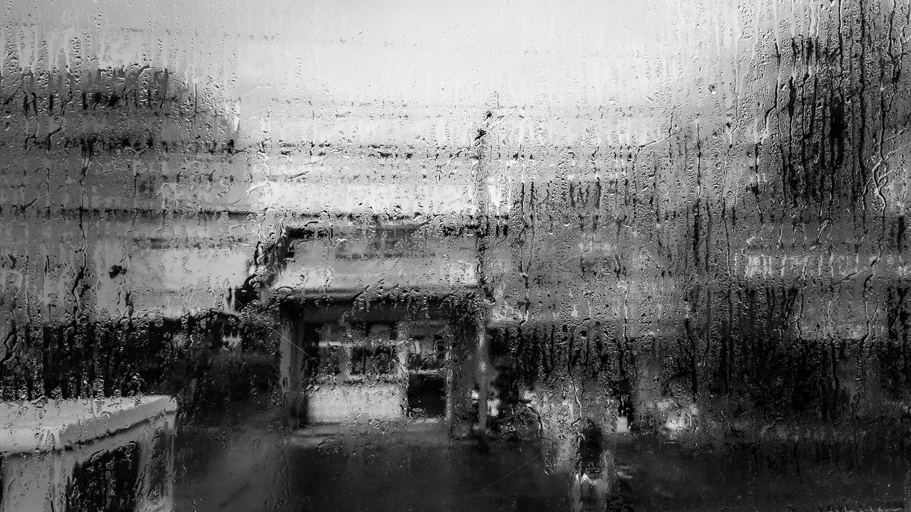 CLOSE-UP OF WET WINDOW IN RAINY SEASON